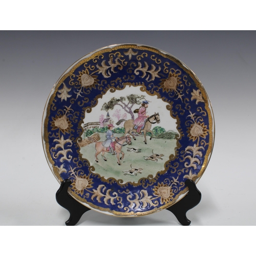 107 - Chinese famille rose pierced basket and stand and a plate with blue and gilt border (2) 30cm.