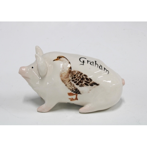 112 - Griselda Hill Pottery pig, painted with a duck and named Graham, with painters initials ES, 15cm.