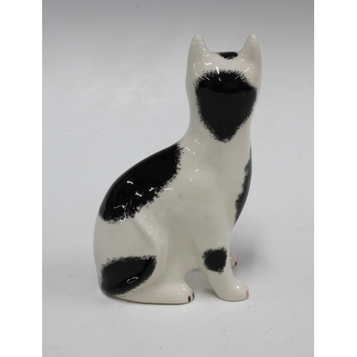 114 - Griselda Hill Pottery Wemyss black and white cat, with painters initials RR, 11 x 17cm.