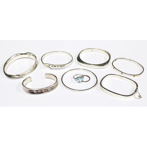 12 - Seven contemporary silver bangles to include one  inscribed Tiffany & Co, together with a silver dre... 