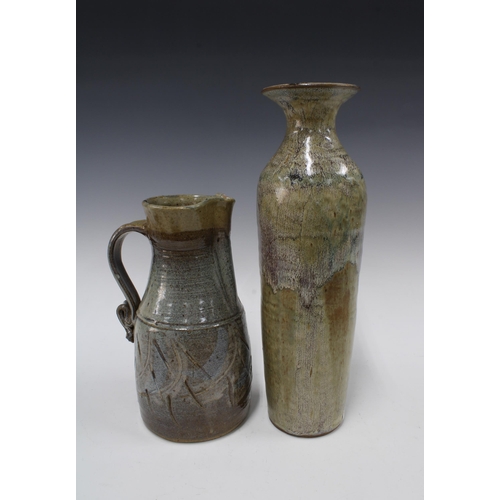 148 - Studio pottery vase of tall & slender form together with a studio pottery jug (2) 12 x 38cm.