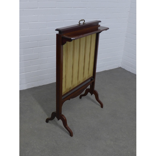 224 - Mahogany screen with plated fabric sliding panel and a candle shelf, 62 x 97cm.