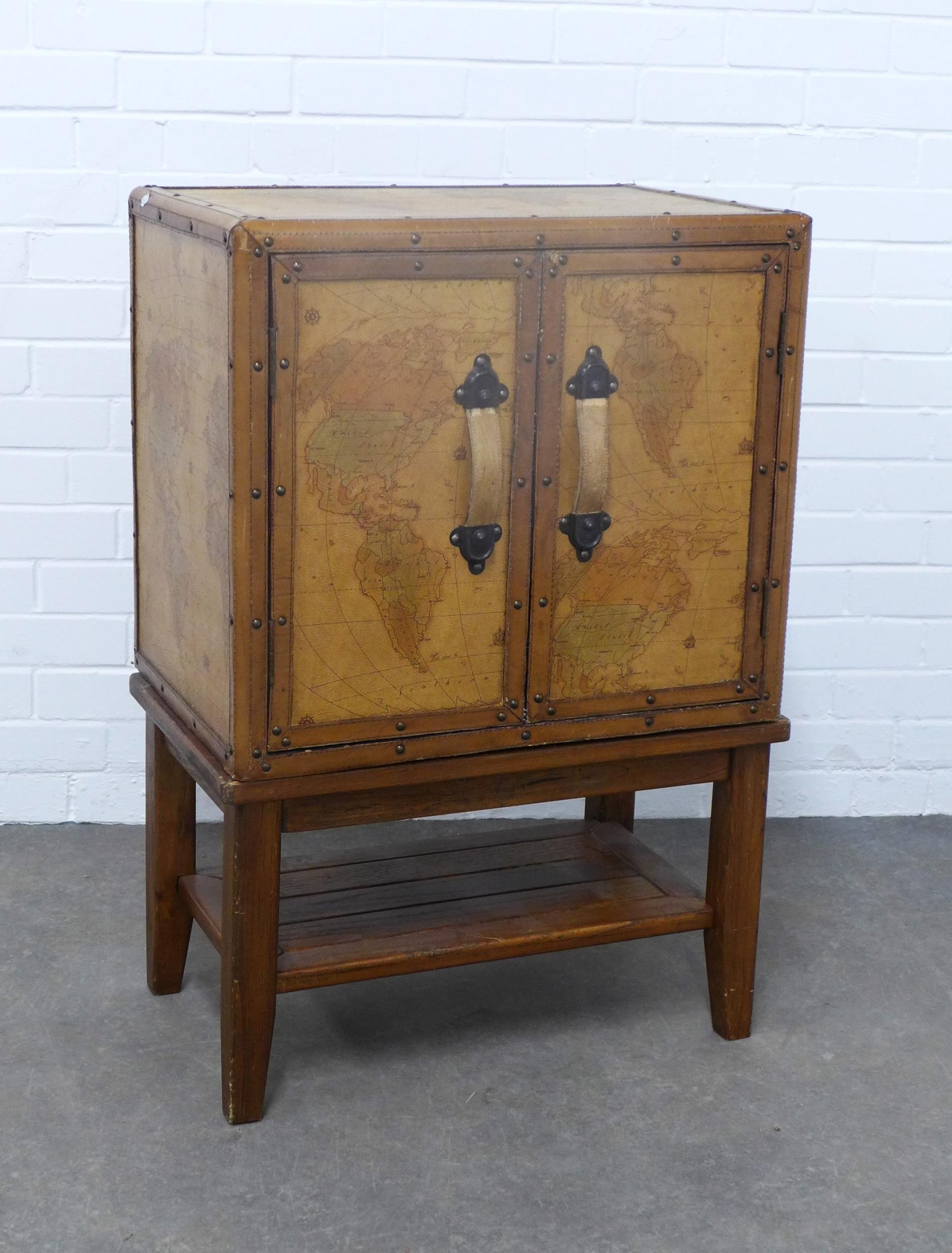 A vinyl upholstered 'Atlas' cupboard on a wooden slatted luggage style ...