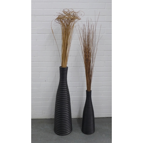 242 - Two contemporary floor standing ribbed vases, with rushes, 90cm high. (2)