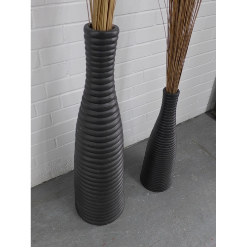 242 - Two contemporary floor standing ribbed vases, with rushes, 90cm high. (2)