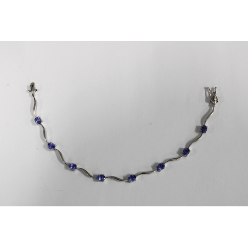 27 - BROWNS of South Africa 9ct white gold tanzanite bracelet, claw set with eight oval tanzanites, signe... 