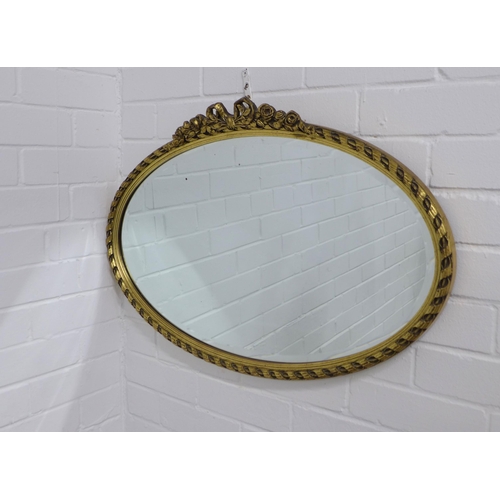 314 - Gilt framed oval wall mirror, 73 x 49cm.