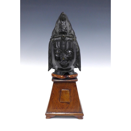 337 - Modern bronze patinated Thai Buddha head on wooden base, 43cm high