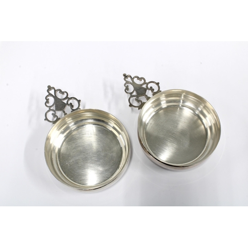 34 - A pair of  George VI silver wine tasters, each with a circular bowl and pierced handle, Sheffield 19... 
