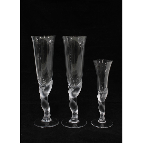 371 - A pair of French champagne flutes with figural stems together with a smaller glass, 25cm (3)