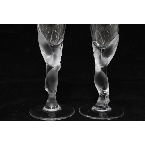 371 - A pair of French champagne flutes with figural stems together with a smaller glass, 25cm (3)