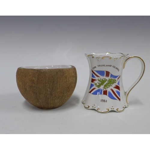 409 - Mug commemorating the liberation of the Falkland Islands, 10cm, together with a studio pottery cocon... 