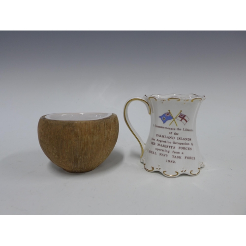 409 - Mug commemorating the liberation of the Falkland Islands, 10cm, together with a studio pottery cocon... 