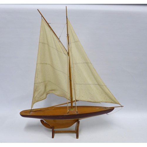 416 - Model pond yacht with two cloth sails, on stand, 73 x 90cm