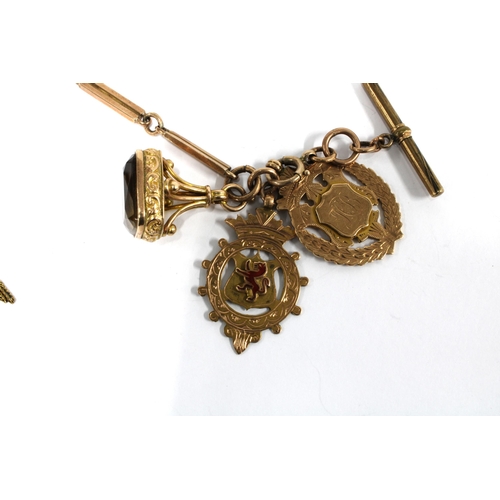 58 - Watch chain, clasp stamped 9ct with an unmarked T-bar, a 9ct gold swivel fob and two 9ct gold medals... 