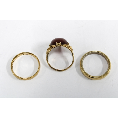 59 - Two 18ct wedding bands and a cornellian dress ring set in yellow metal (3)