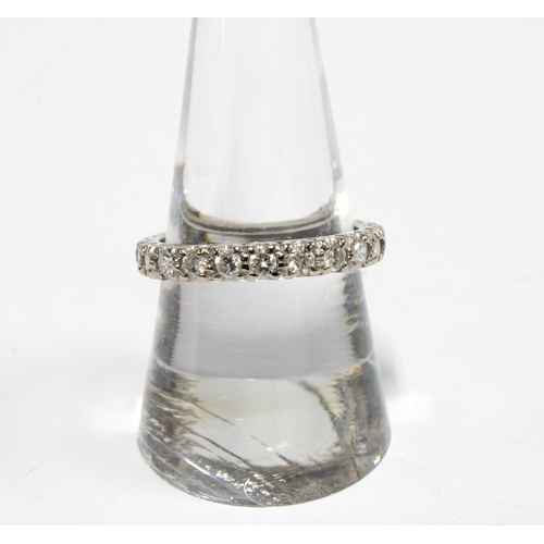 78 - A diamond full eternity ring set in unmarked white metal