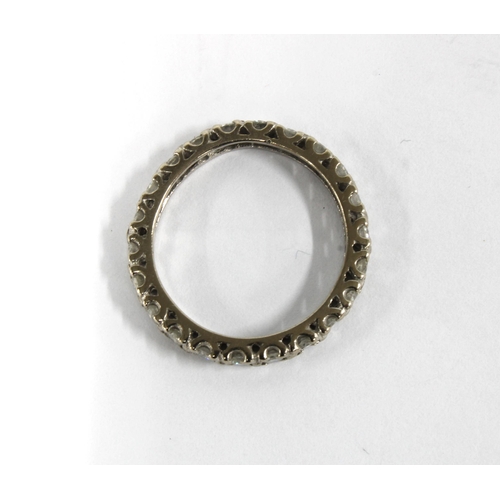 78 - A diamond full eternity ring set in unmarked white metal