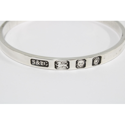 87 - London 1988 silver hallmarked bangle, a small Birmingham silver photograph frame, 15 x 10cm and a si... 