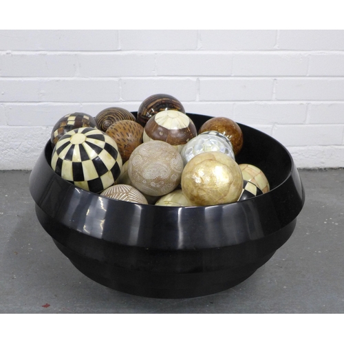 438 - A large modern bowl/ tub containing a quantity of spheres in wood, rope and shell, etc (a lot)