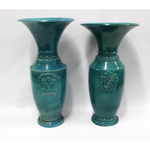 455 - Two raku turquoise glazed baluster vases, each with a flared rim and armorial style crest, taller 62... 