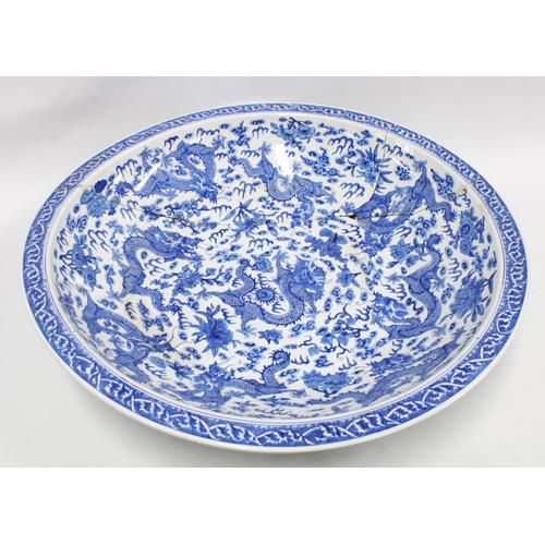 463 - Large Chinese blue and white dragon bowl, with five clawed dragons chasing pearls of wisdom,  (A/F w... 