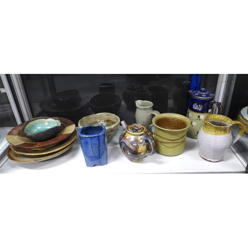 145 - A collection of studio pottery to include a raku glazed bowl, teapot, jug and various bowls, (11)