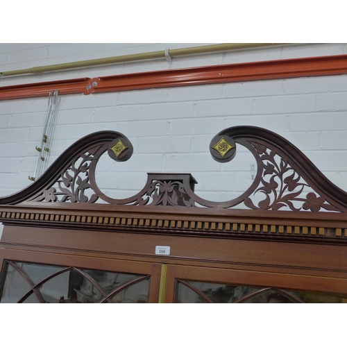 299 - Mahogany bookcase cabinet with swan neck fretwork top and dentil frieze over a pair of astragal glaz... 