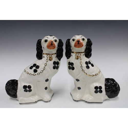 160 - Pasir of black and white pottery chimney spaniels by Wood (2) 28cm