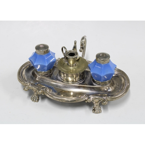 357 - Epns desk inkwell with two blue glass wells and a candle snuffer to centre, standing on paw feet, 27... 