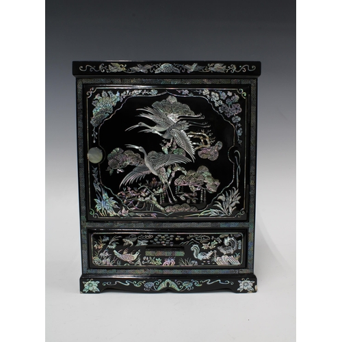 361 - Black lacquered and shell inlaid cabinet, with internal drawers and a long base drawer, 34cm tall