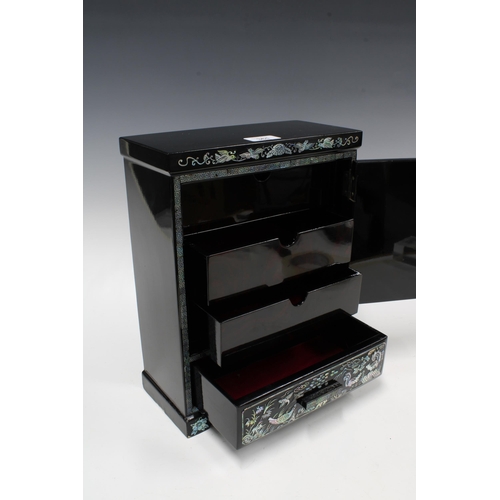 361 - Black lacquered and shell inlaid cabinet, with internal drawers and a long base drawer, 34cm tall