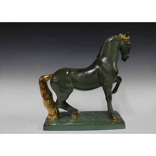 364 - Green and gilt glazed horse on a rectangular plinth base, (small glaze nick to tip of one ear) 42 x ... 