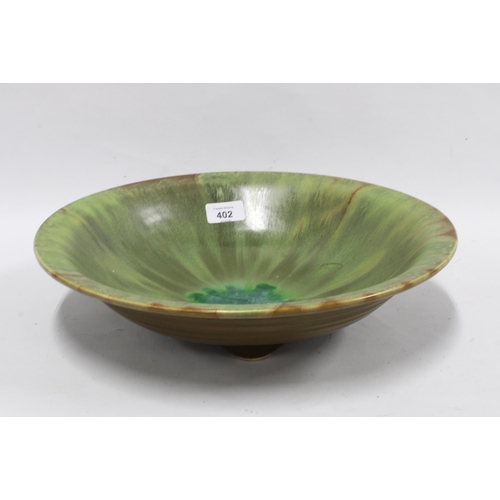 402 - Studio pottery bowl with green streaked glaze, 36cm diameter