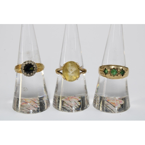 65 - Three 18ct gold dress rings and four 9ct gold rings together with a 9ct gold charm with two miniatur... 