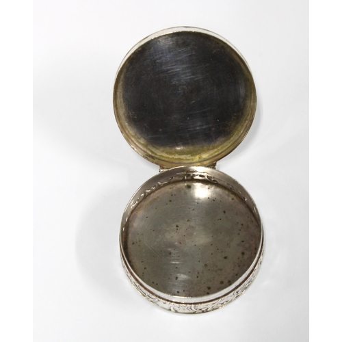 91 - Dutch silver pill box, circular form, hinged lid with an engraved pattern and with repousee side dec... 