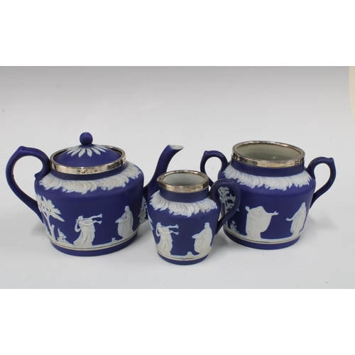 102 - Adams Tunstall blue and white Jasper teapot, cream jug and sugar owl, with silver mounts for London ... 