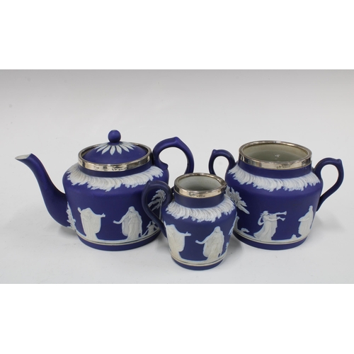 102 - Adams Tunstall blue and white Jasper teapot, cream jug and sugar owl, with silver mounts for London ... 