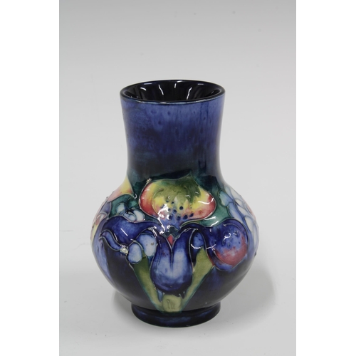 107 - Moorcroft Orchid pattern vase, blue ground with impressed factory marks, 9 x 13cm.