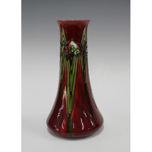 108 - Minton Secessionist No1 slender baluster vase, tube lined with stylised flowers to a deep red ground... 