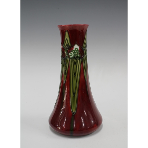 108 - Minton Secessionist No1 slender baluster vase, tube lined with stylised flowers to a deep red ground... 