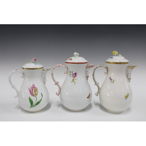 128 - Three Meissen coffee pots of baluster form and painted with flowers, each with a rosebud finial (3) ... 