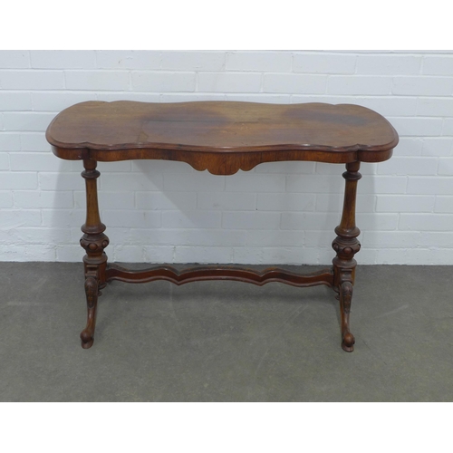 239 - Victorian mahogany table, shaped top on carved end supports with wavy stretcher, 167 x 69 x 53cm.