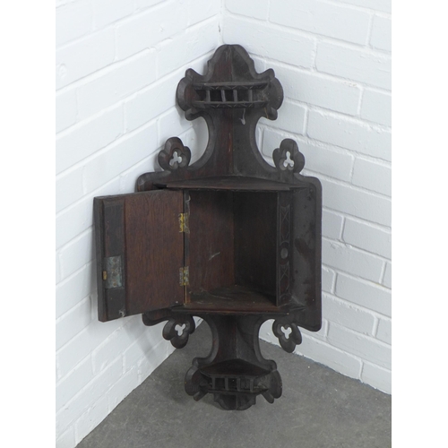 249 - Carved Oak corner hanging cupboard, 38 x 84cm.