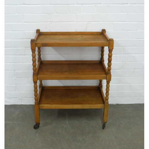 251 - An oak three tier buffet trolley with bobbin supports, , 61 x 80 x 38cm.