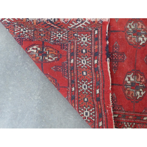 267 - Bokhara rug, red field with three rows of seven guks,  110 x 89cm.