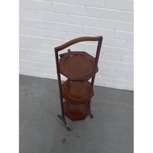 289 - A mahogany three tier folding cake stand, 27 x 84cm.