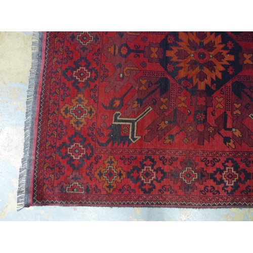 295 - Persian / Afghan rug with red field, 208 x 130cm.