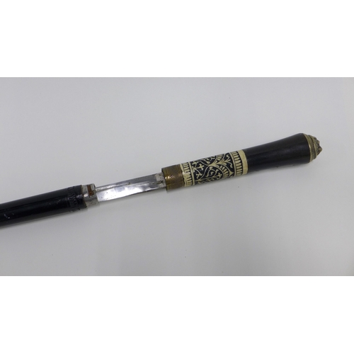 325 - Ebonised sword stick with a brass mounted faux ivory handle and an early 20th century parasol (2)