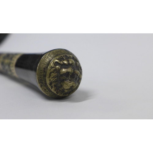 325 - Ebonised sword stick with a brass mounted faux ivory handle and an early 20th century parasol (2)